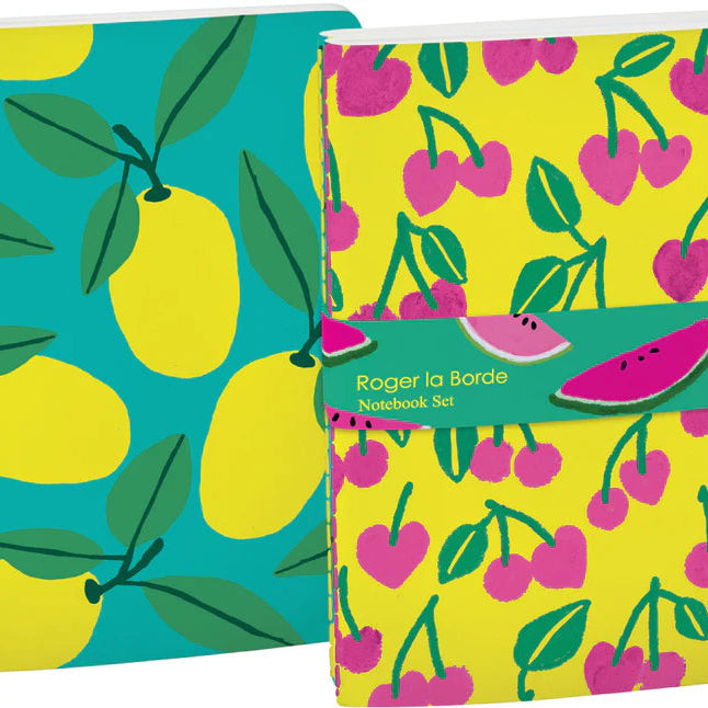 Roger la Borde Cute Fruit A5 Notebook Set featuring two colourful softback notebooks, one with yellow cherries on neon background and one with bold lemons on teal cover, tied together with a green bellyband.
