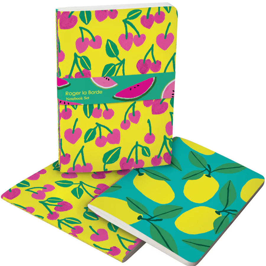 Set of two Roger la Borde Cute Fruit A5 Notebooks displayed open and stacked, with illustrated cherry and lemon covers, colourful spine stitching, and FSC-certified paper.