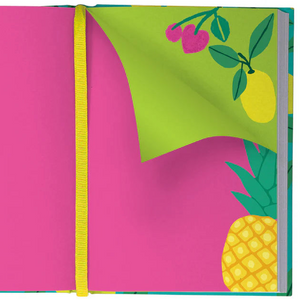 Inside view of the Cute Fruit Illustrated Journal showing a vivid pink double-page spread with illustrated pineapples and a yellow ribbon marker, partially revealing a green page corner with cherries and lemons.