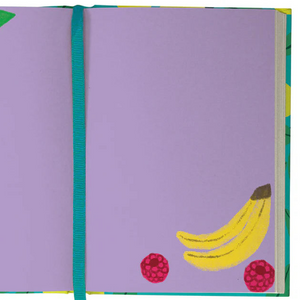 Purple fruit-themed spread from the Cute Fruit Illustrated Journal, with illustrated papaya, bananas, and raspberries framing the pages, alongside a teal ribbon bookmark.