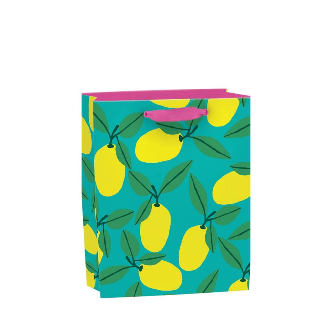 Small recyclable lemon gift bag with Anne Bentley’s bold yellow fruit and green leaf illustrations on a turquoise background, featuring pink grosgrain ribbon handles and a matching gift tag.