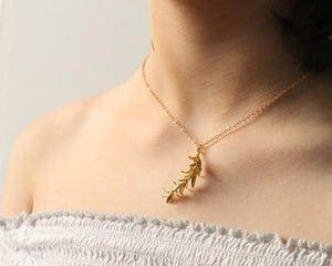 Model wearing the Rosemary Botanical Leaf Necklace, showcasing its elegant design and gold-plated chain.