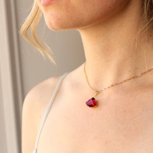 Model wearing the Ruby Deco Necklace, showing its elegant Art Deco-inspired fan shape.