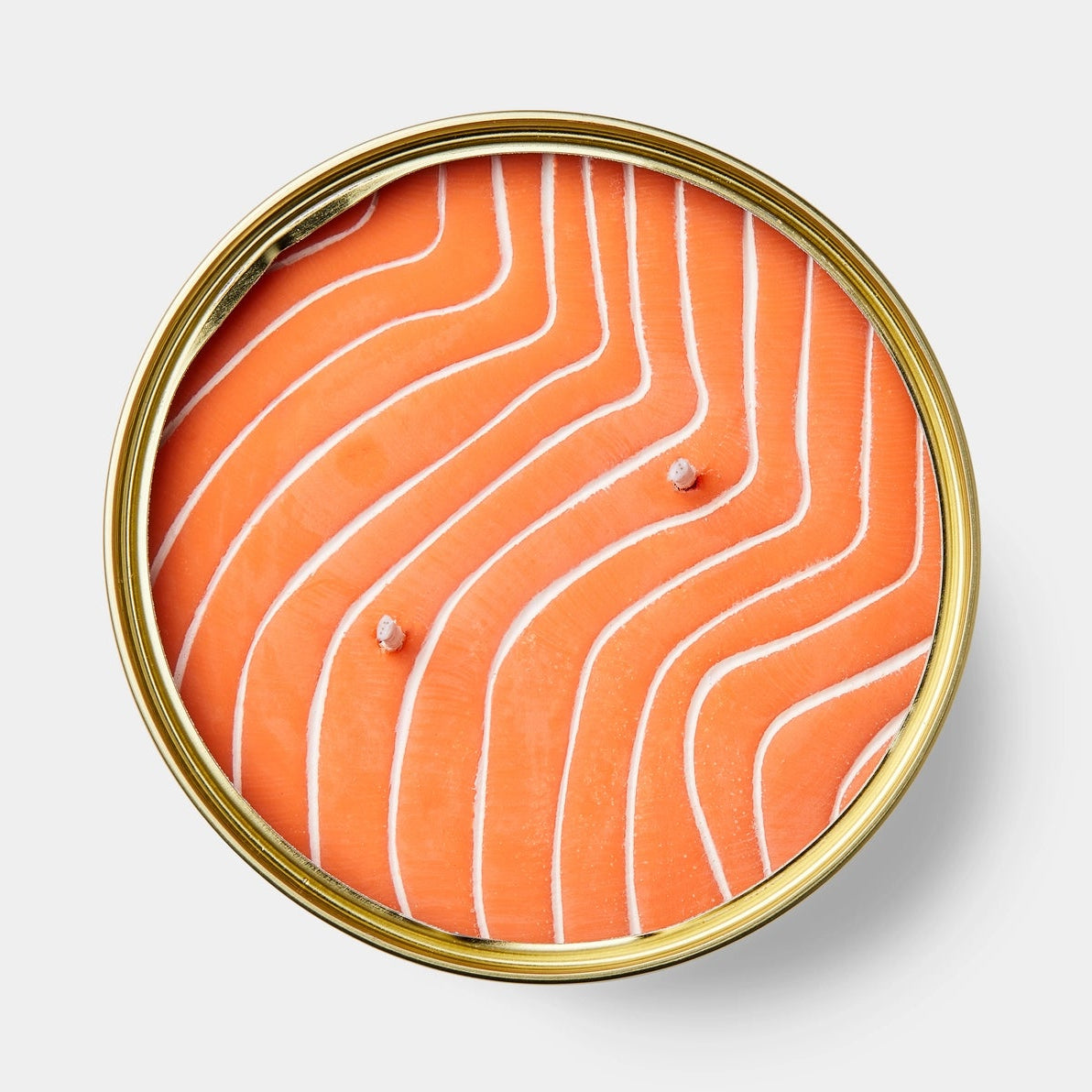 Top view of the Orange Salmon CandleCan showing triple wicks embedded in hyper-realistic orange wax with salmon-like marbling.