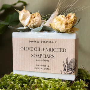 Sandalwood olive oil soap displayed on moss, highlighting its botanical charm.