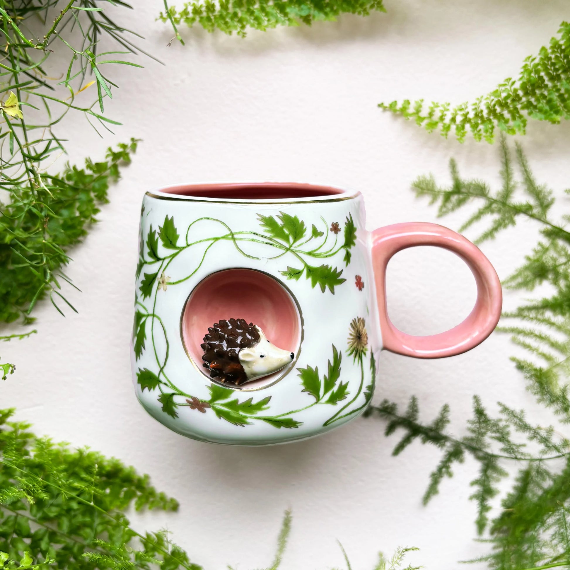 Ceramic Secret Garden 3D Hedgehog Mug with pink handle and floral design.