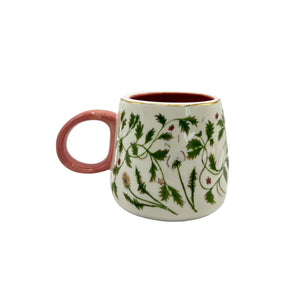Floral ceramic mug with pink handle and gold foil details.