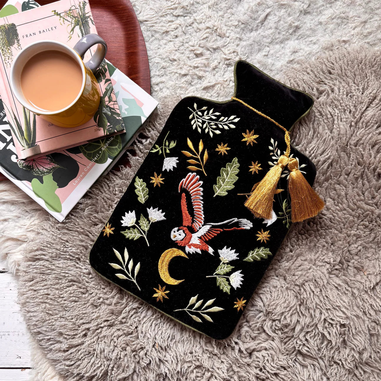 Secret Garden Owl Hot Water Bottle with embroidered owl and gold tassel on black velvet cover.