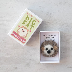 Flat lay of the matchbox and hedgehog with the lid removed, showing the adorable wool felt hedgehog inside.