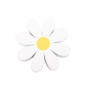 Stack of white daisy-shaped coasters with yellow centres, side angle.