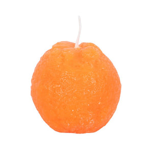 Close-up of a single orange-shaped candle with textured peel surface.