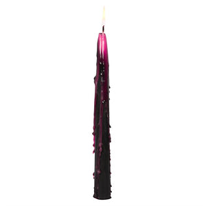 Single lit black taper candle dripping vivid pink wax – vampire bleeding effect candle for Halloween ambience.