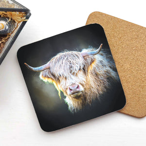 Close-up of Shadow Gaze Highland Cow Coaster featuring a detailed, moody portrait of a Highland cow, placed on a white surface with a cork backing.