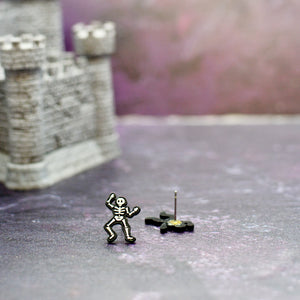 One Skeleton Stud Earring with its backing removed, showing stainless steel post.