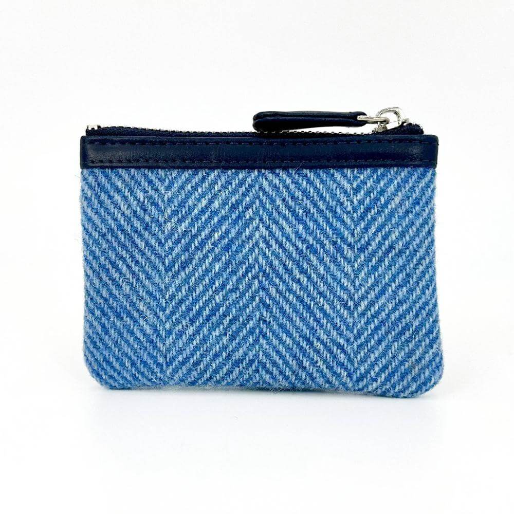 Back view of blue herringbone Harris Tweed coin purse with black trim.
