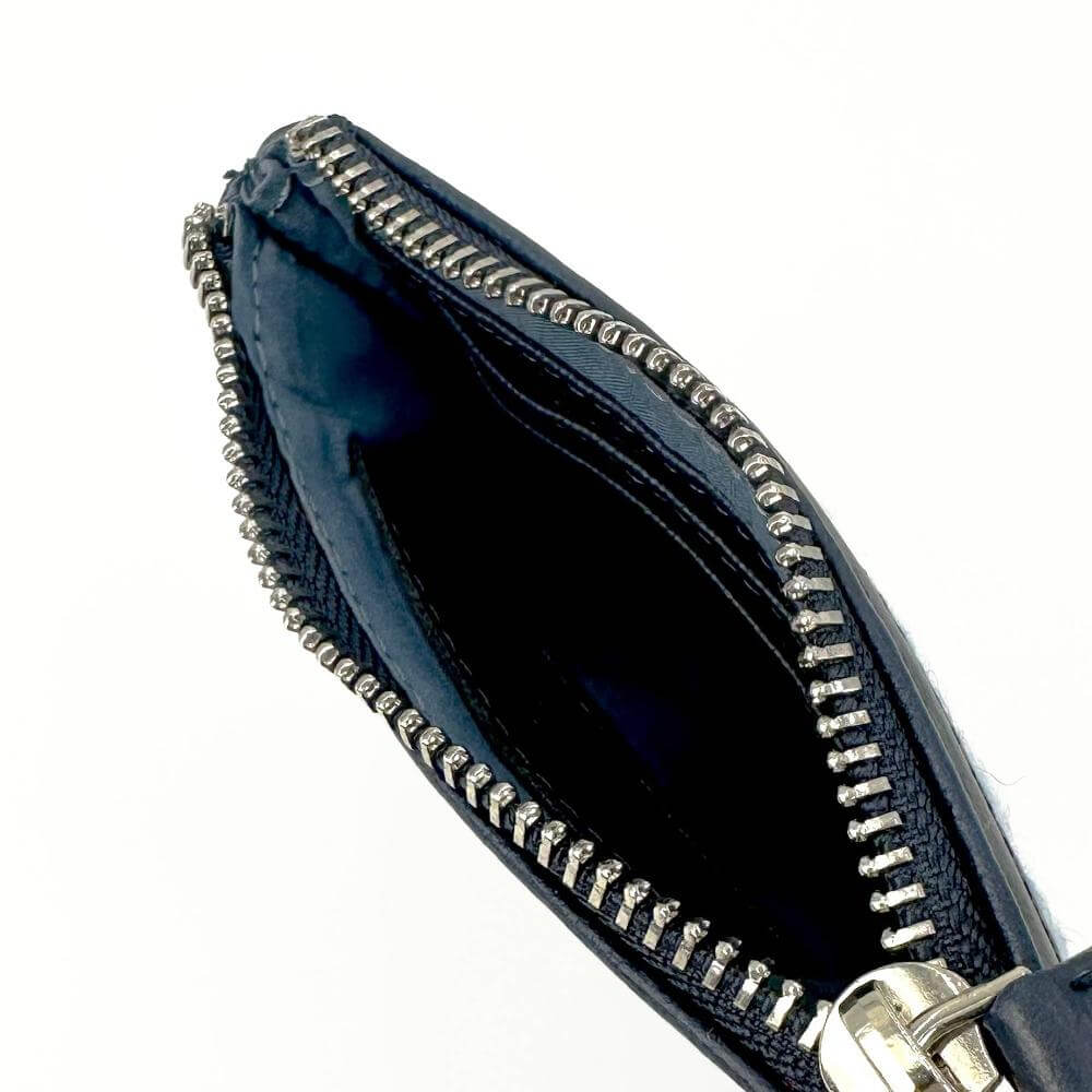 Interior view of zip coin purse showing compartments for cards and coins.