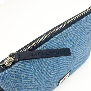 Close-up of silver zip on Harris Tweed bag with embossed Maccessori leather zip pull and tweed texture.
