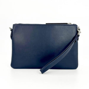 Rear of sky blue Harris Tweed clutch featuring navy faux leather back and detachable wrist strap.