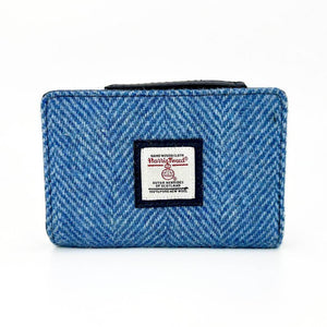 Front of Sky Blue Harris Tweed Zip Purse with Harris Tweed label in centre and classic herringbone wool pattern.