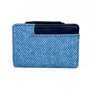 Back of Harris Tweed Zip Purse in sky blue herringbone wool with navy leather trim and outer slip pocket.