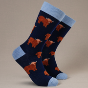 Fluffy Coo Socks in navy with highland cow pattern on grey background