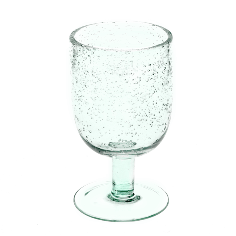 Close-up of a single hand-blown bubble glass with a blue tint and rounded shape, showing textured air bubbles throughout.