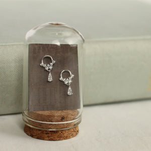 Sterling silver crystal mini hoop earrings with droplet design, styled inside a glass cloche on a cork base for an elegant, vintage-inspired jewellery display.