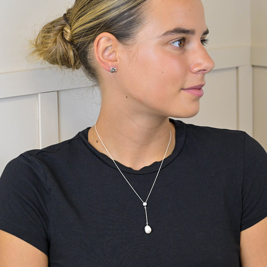 Side view of Sterling Silver Crystal & Pearl Drop Necklace on model.