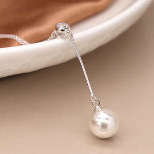 Sterling Silver Crystal & Pearl Drop Necklace on display with ivory pearl and CZ crystal detail.