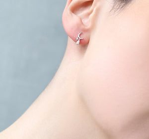 Close-up of Crescent Moon Earrings Worn on Ear – Minimalist Jewellery.