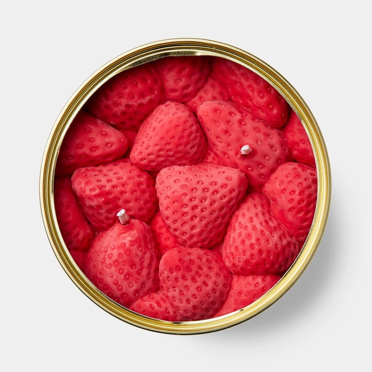 Top-down view of the Ripe Strawberries CandleCan showing detailed pink wax strawberries packed inside the gold tin.