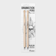 Retail packaging of Suck UK Drumstick Pens set with rock-themed backing card, featuring skull artwork and “Play at Work” slogan.