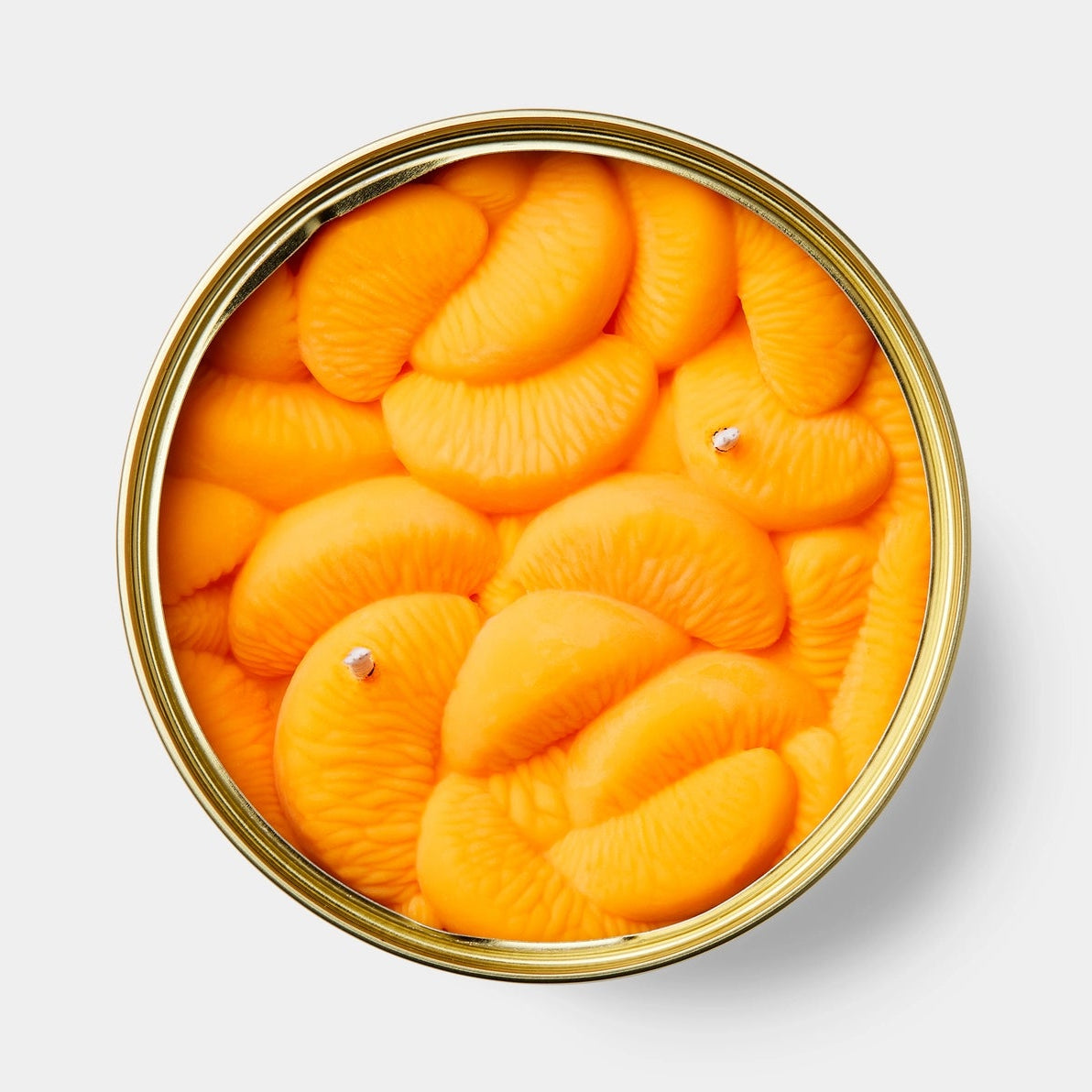 Closed CandleCan tin labelled “Peeled Tangerines” with illustrated fruit segments on the lid, designed to mimic gourmet canned food packaging.