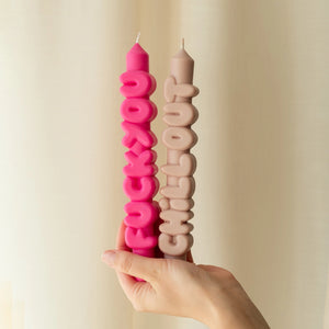 Some things are better said in wax.
Whether you’re feeling zen or just done with the world, this unapologetic candle set is here to do the talking so you don’t have to. Featuring Fck You* in hot pink and Chill Out in cool cream, these hand-poured taper candles are the ultimate contradiction—bold and playful, sweary and soothing.

Each one is made entirely by hand, from the shapely letters to the smooth finish. Unscented and attitude-filled, they’re the perfect centrepiece for a dinner party, a passive-aggre