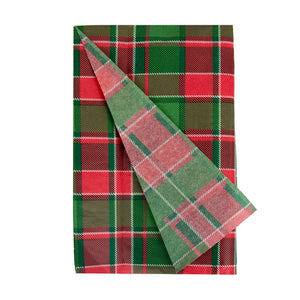 Folded red and green tartan tissue paper with one corner turned over, showcasing festive Christmas gift wrap pattern.