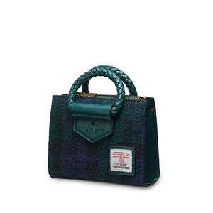 Angled: The Mini Arran Tote with Black Watch Harris Tweed® with a green PU leather & braided handle. 