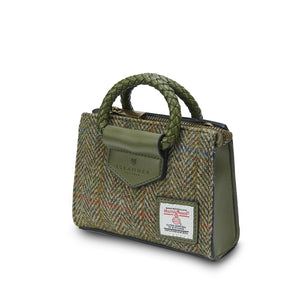 Angled: The Mini Arran Tote with Chestnut Herringbone Harris Tweed® with a green PU leather & braided handle. 