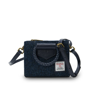 Straight View: The Mini Arran Tote with Navy Herringbone Harris Tweed® with a navy PU leather braided handle and shoulder strap.