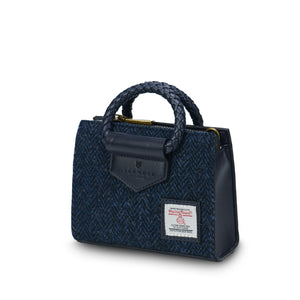 Angled:  The Mini Arran Tote with Navy Herringbone Harris Tweed® with a navy PU leather & braided handle. 