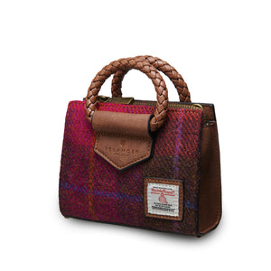 Angled: The Mini Arran Tote with Red Tartan Harris Tweed® with a brown PU leather & braided handle. 