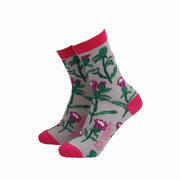 Pair of Women’s Thistle Bamboo Socks featuring a vibrant Scottish thistle design on a grey background with pink accents.