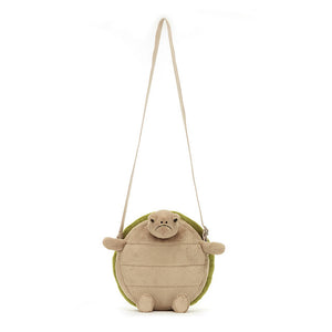 Straight On View: Front view of the adorable (despite the frown!) Jellycat Timmy Turtle Bag. Features a luxuriously soft beige body with a detailed green embroidered shell and a grumpy expression. A strong webbed strap ensures comfortable carrying. This surprisingly charming turtle bag holds all your essentials (except maybe grudges!). 