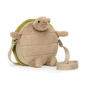 Angled View: A grumpy shell with a heart of gold! The Jellycat Timmy Turtle Bag leans in, showcasing its textured beige tummy and embroidered green shell with a grumpy pout. A strong webbed strap lets Timmy ride comfortably on your shoulder. Perfect for grumpy glam adventures! 