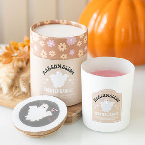 Toasted Marshmallow candle in white glass jar with ghost design and pink wax inside.