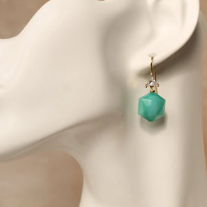 Turquoise hexagon glass drop earring with gold hook and crystal triangle shown on mannequin ear, art deco jewellery.
