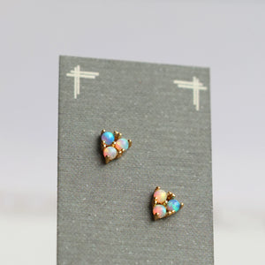Turquoise opal triangle earrings displayed on a grey backing card, showing iridescent colours and delicate gold settings.