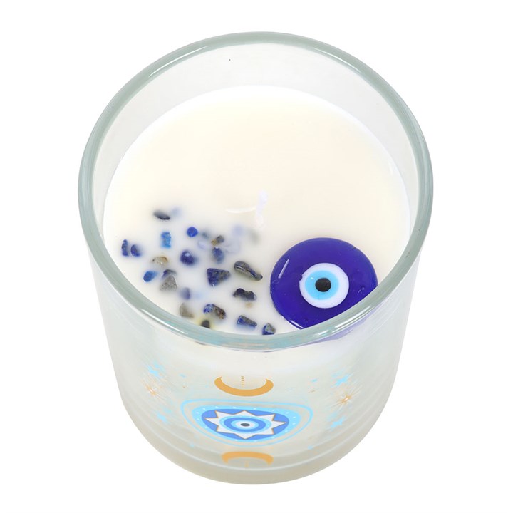 Top view of crystal-infused white rose candle with protective evil eye charm inside the wax.