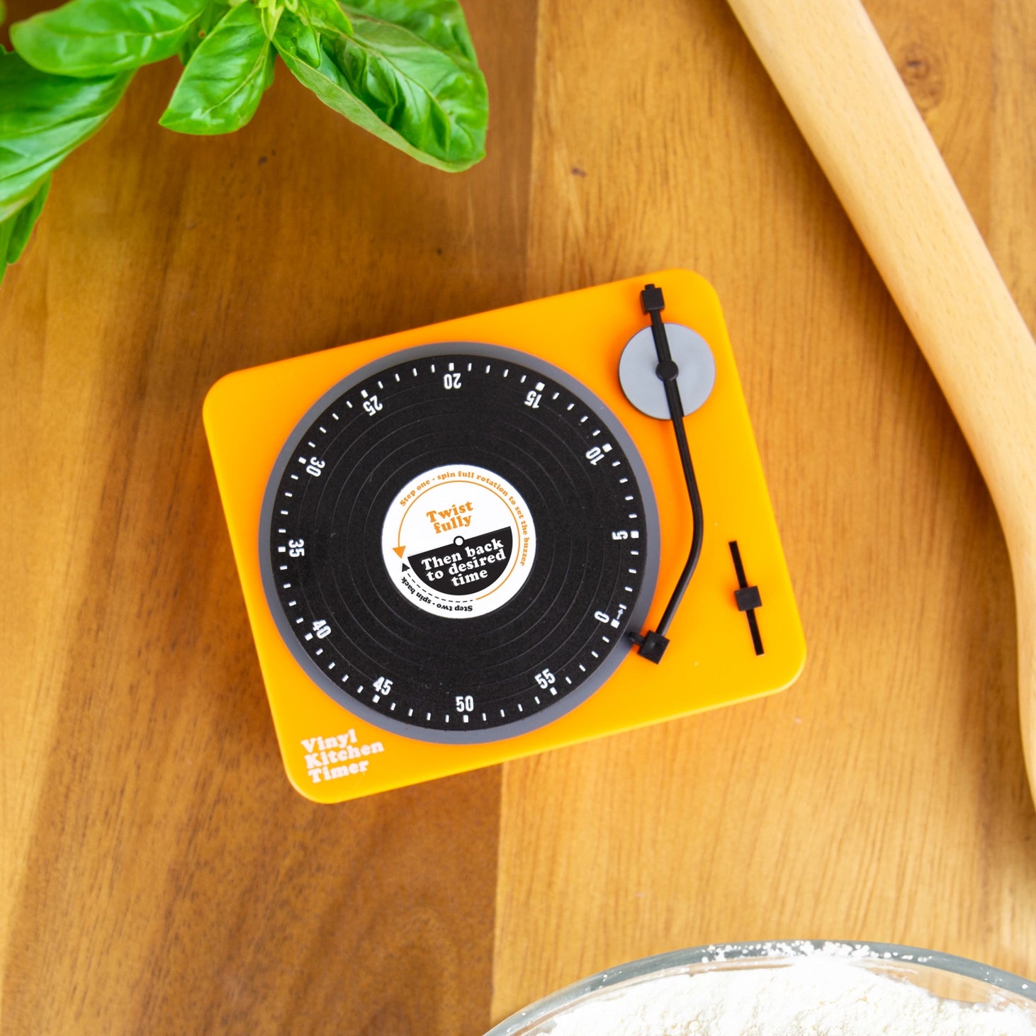 Orange Vinyl Kitchen Timer styled like a record player on a kitchen counter with basil and flour.