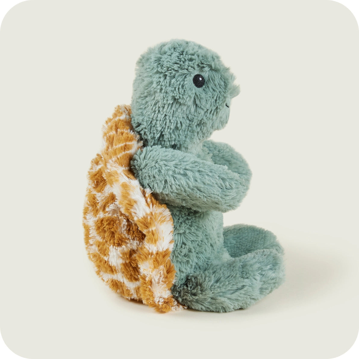 Warmies Baby Turtle turned sideways with plush arms and legs visible.