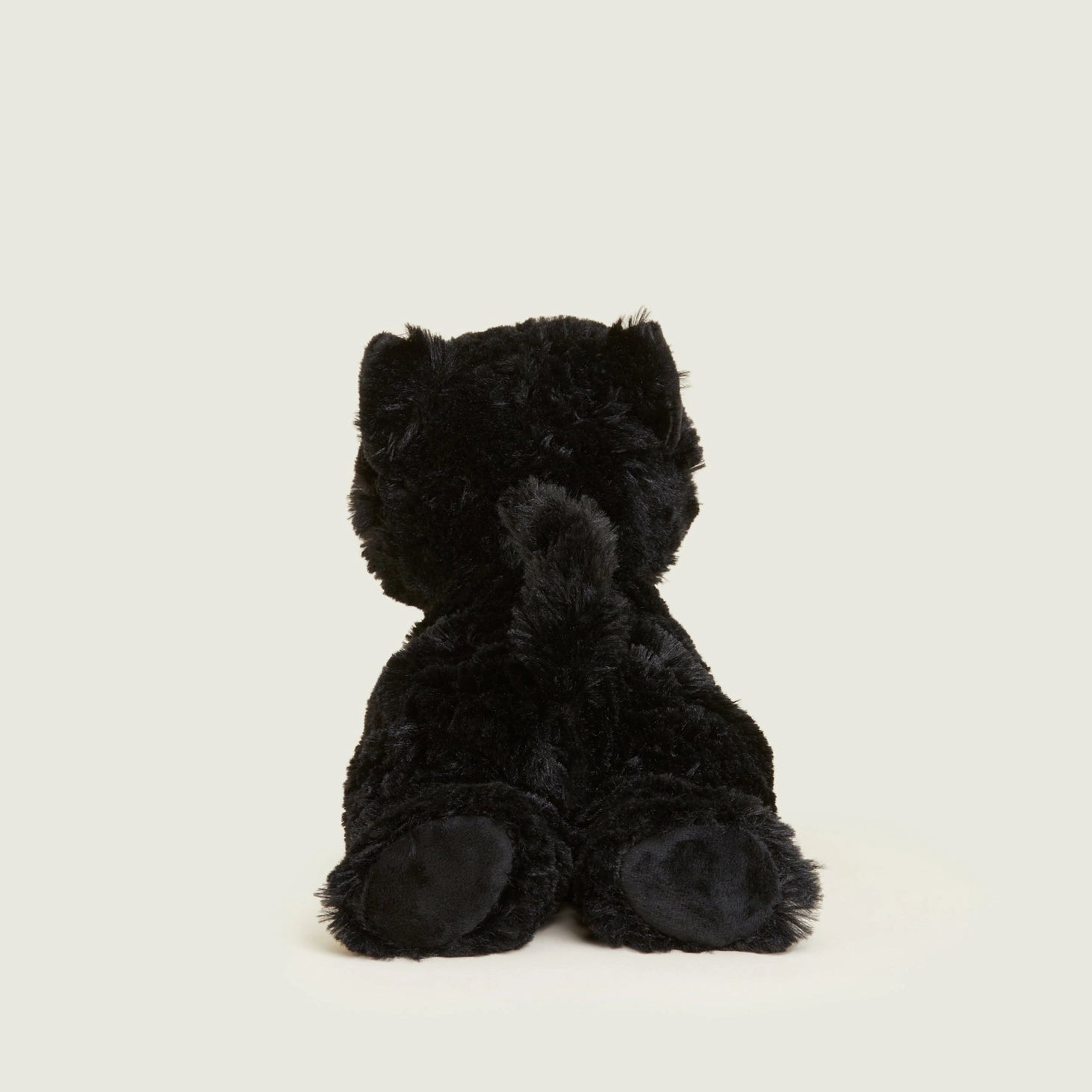 Rear view of Warmies Black Cat microwavable soft toy with raised tail and soft padded paws.